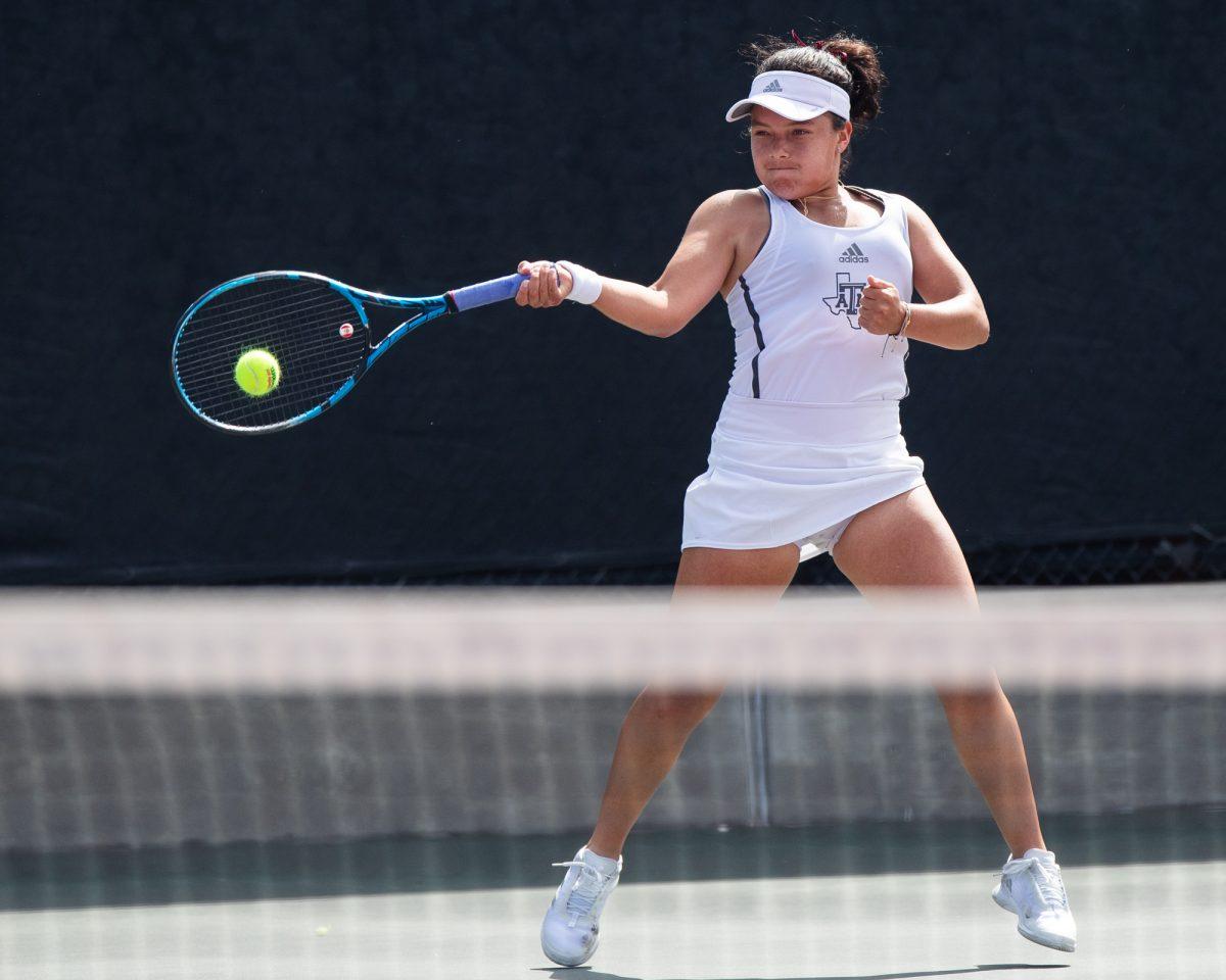 Freshman Lucciana Perez hits the ball at Texas A&M's match against Florida on Sunday, March 3, 2024, at the Mitchell Tennis Center. (© Connor May/The Battalion)