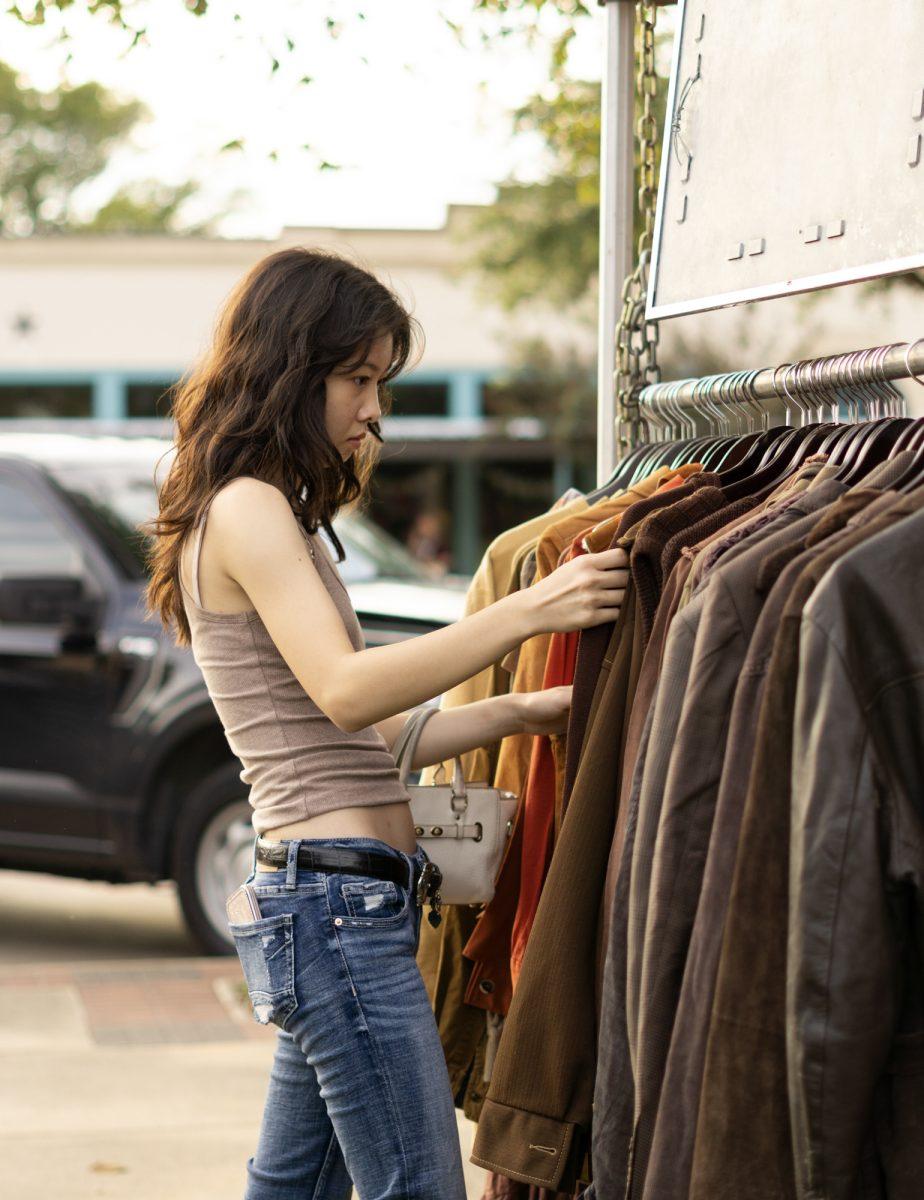 A customer browses vintage clothing at the Bygone Vintage market on Friday, Oct. 6th, 2024 at Tavo Coffee Co.