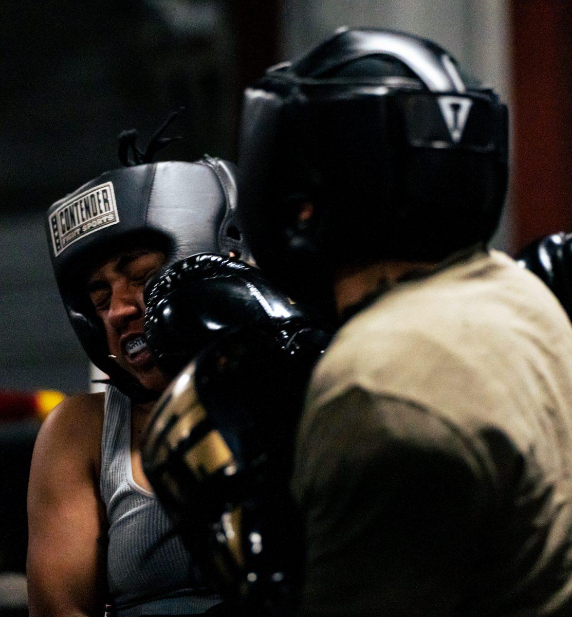 Fighter Charles Villegas hooks sparring partner Hailey Artega during Farmers Fight NIght sparring practice on Tuesday, Feb. 20, 2024, at BCS Boxing Club.