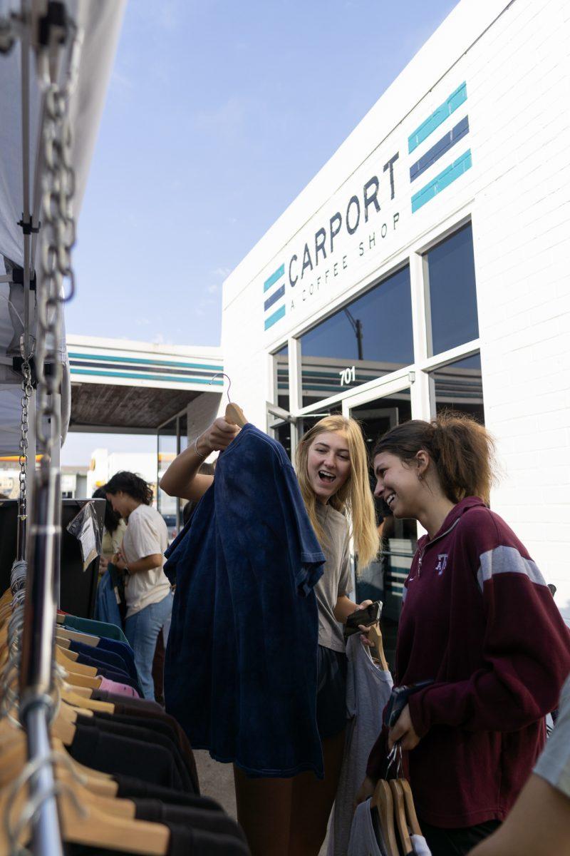Customers admire a shirt at a Bygone Vintage pop-up on Friday, Sep. 15th, 2023 at Carport Coffee.