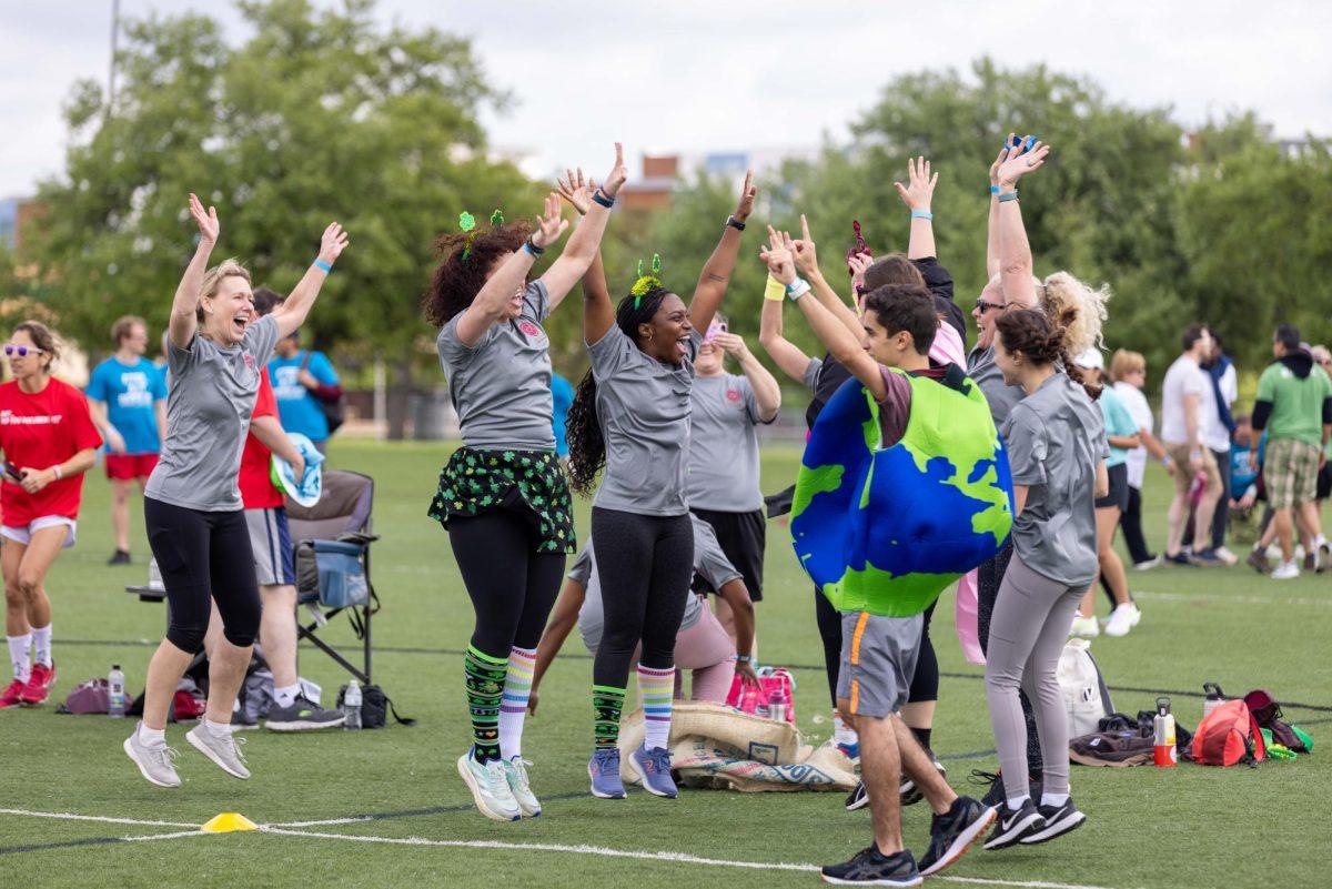 Team Global Engagement celebrates as their last sack runner crosses the finish line during the field day activities at the Penberthy Rec Sports Complex on Friday, March 22, 2024. (Samuel Falade/The Battalion)