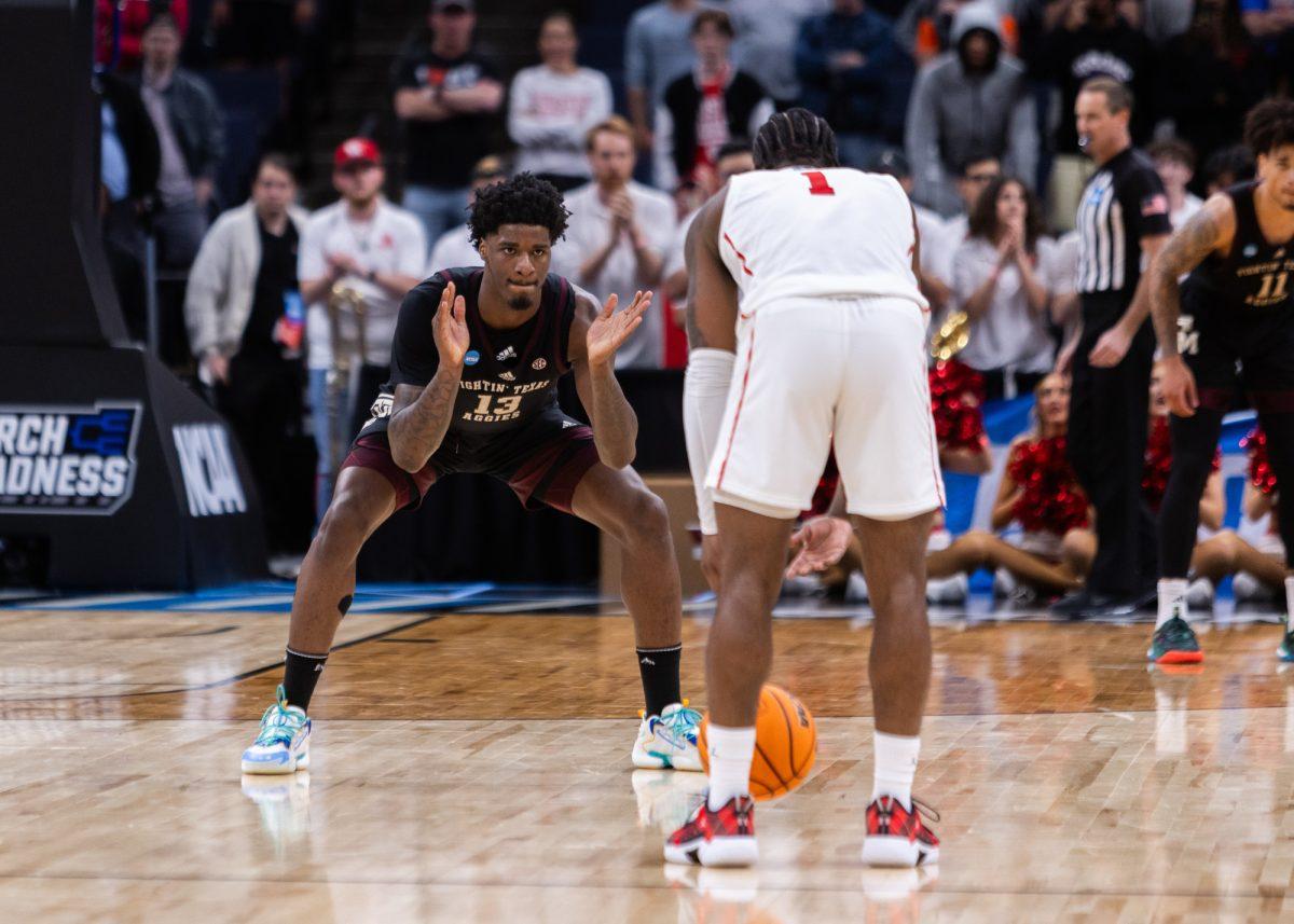 Sophomore F Solomon Washington (13) claps while defending Houston G Jamal Shead (1) during Texas A&M's game against Houston in the second round of the 2024 NCAA Tournament at FedExForum in Memphis, Tennessee, on Sunday, March 24, 2024. (Kyle Heise/The Battalion)