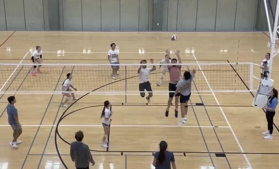 Atmospheric sciences graduate Daniel Jellis makes a block during the Oaks coed rec volleyball teams game on Feb. 7 in the Student Recreation Center. (Photo courtesy of Oaks)