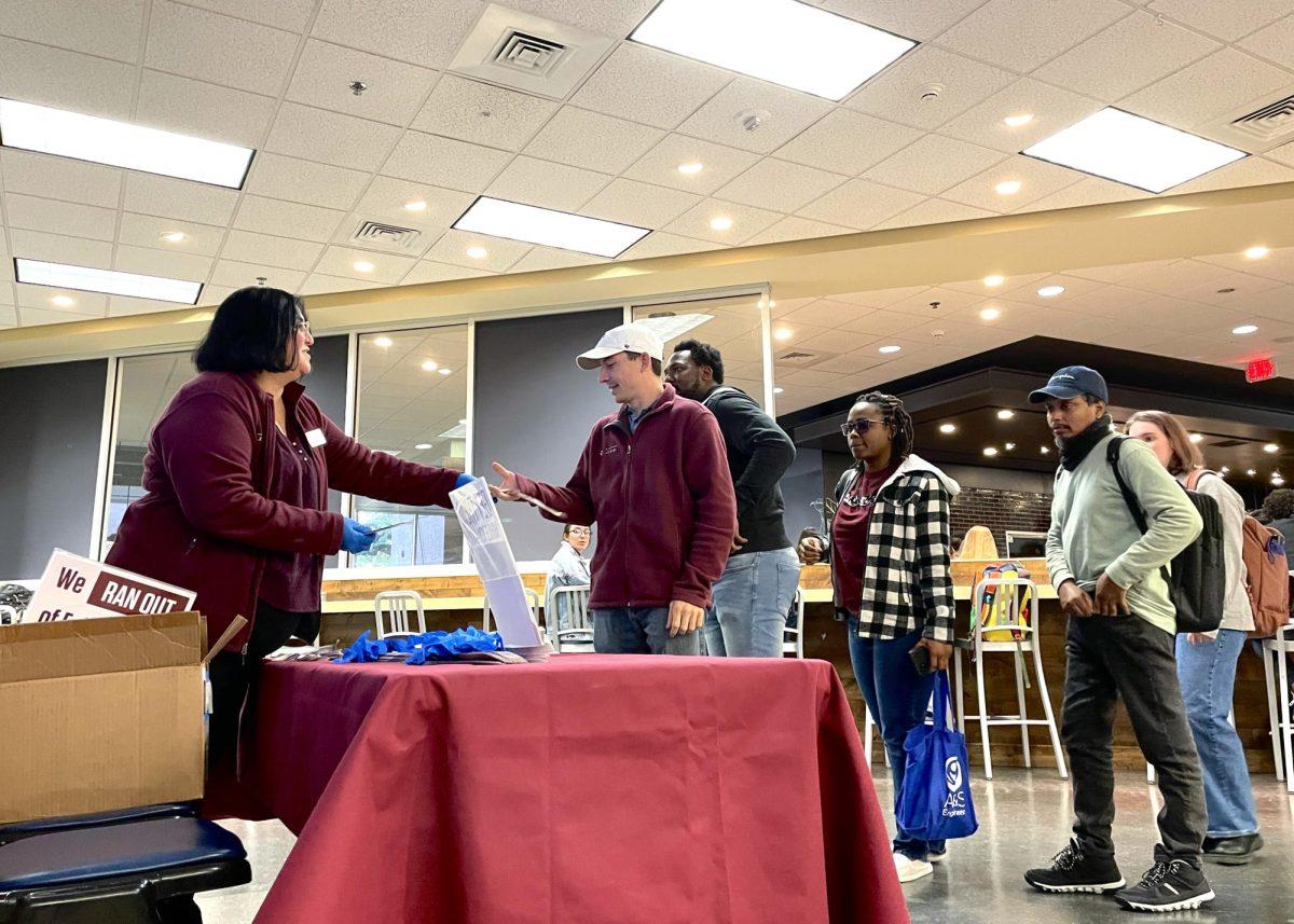 Students wait in line to get eclipse glasses in Evans Library on Tuesday, March 26, 2024. (Kyle Heise/The Battalion) 