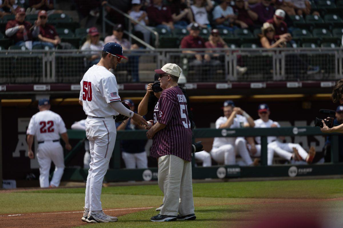 Freshman INF Boots Landry (50) shakes hand with the first pitch thrower during Texas A&Ms game against Mississippi State on March 23rd, 2023 at Olsen Field. (Jaime Rowe/The Battalion)