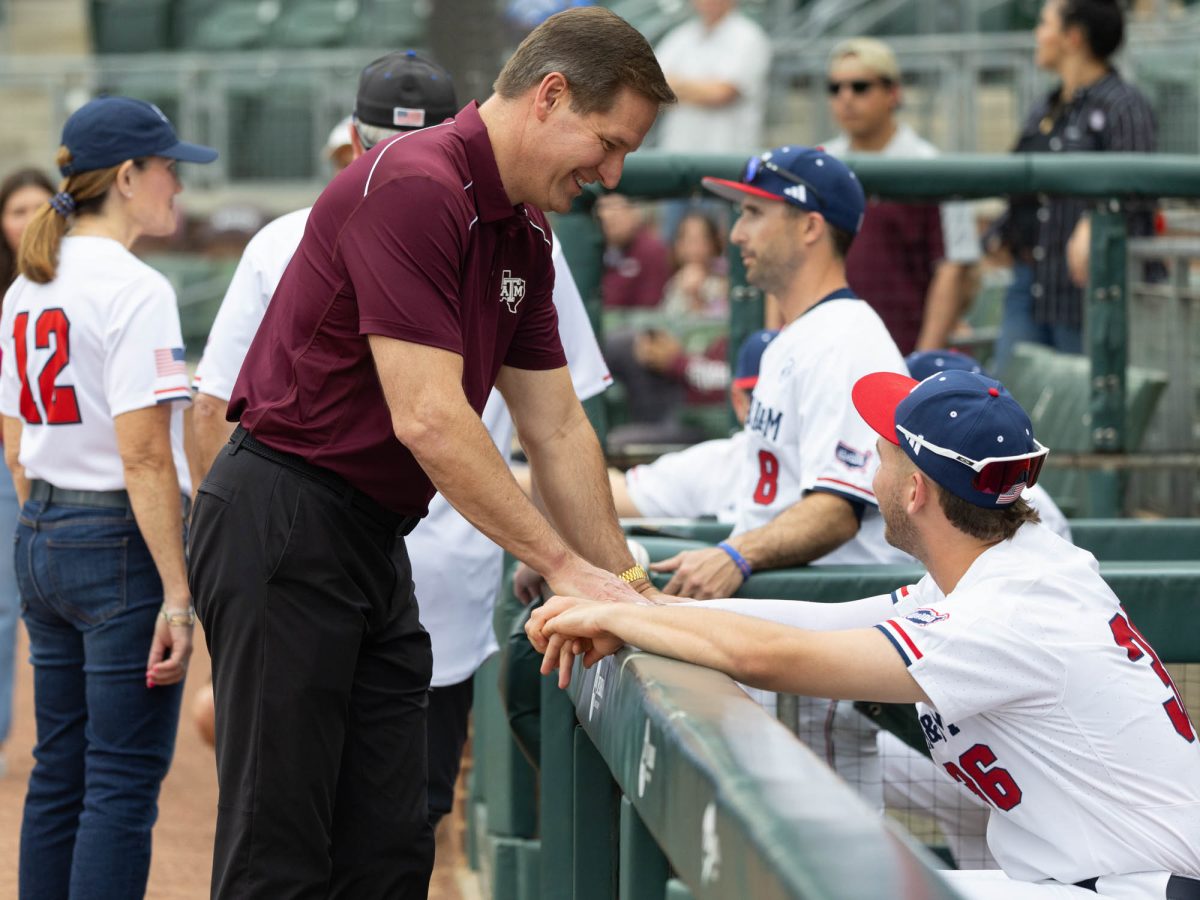 Texas A&M Athletic Director Trev Alberts talks to Texas A&M utility Jett Johnston (36) during Texas A&M’s game against The United States Air Force Academy on Tuesday, April 16, 2024 at Olsen Field. (Hannah Harrison/The Battalion)