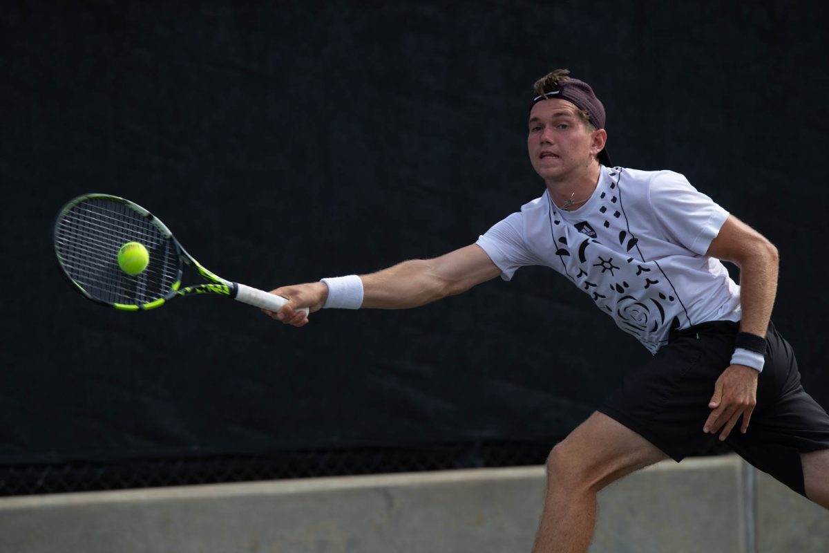 Freshman Grant Lothringer runs to return the ball during Texas A&M’s match against Arkansas on Sunday, April 7, 2024 at Mitchell Tennis Center. (Lana Cheatham/The Battalion)