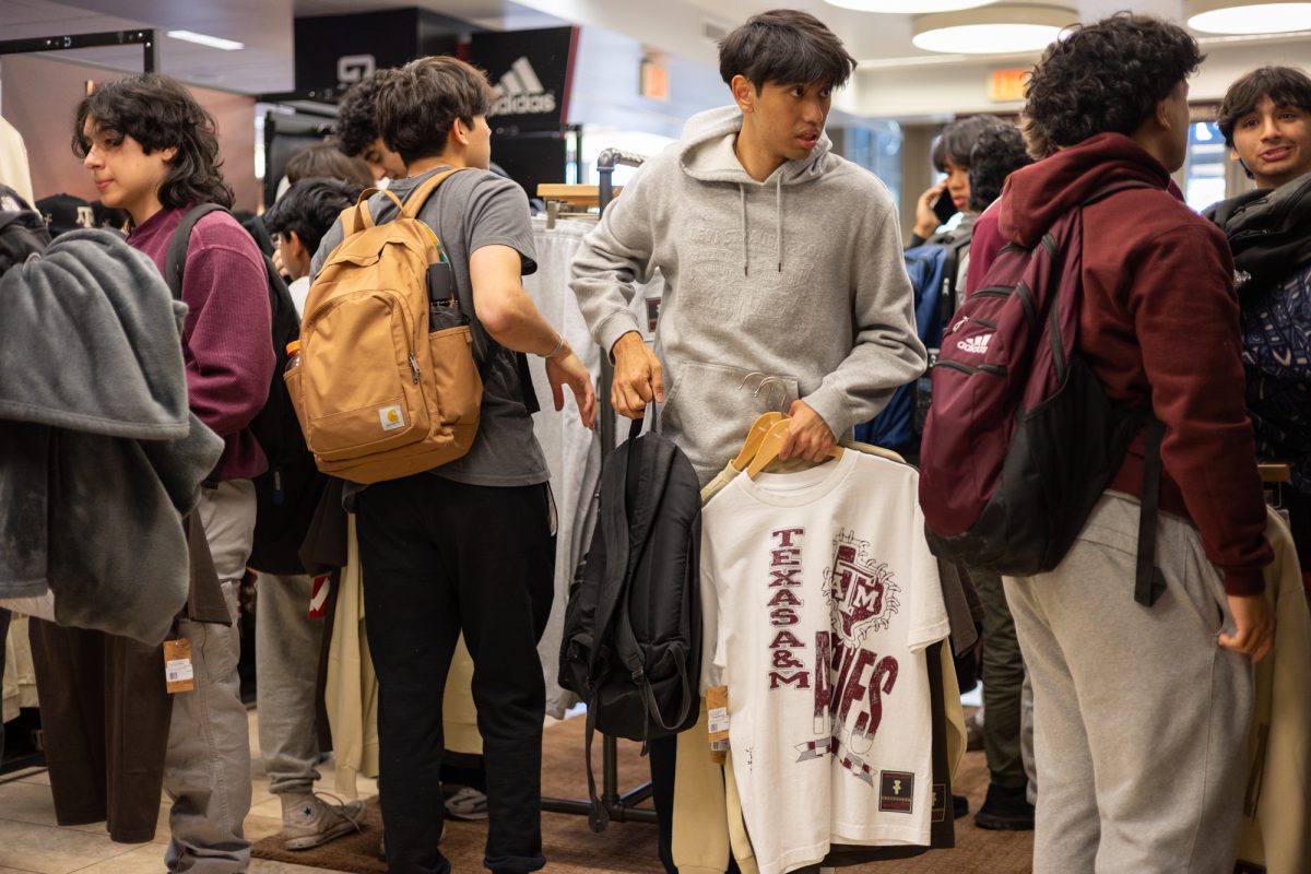 Student holding Texas A&M Cactus Jack t-shirts on Thursday, April 4, 2024, at the Texas A&M bookstore. (Adriano Espinosa/The Battalion)