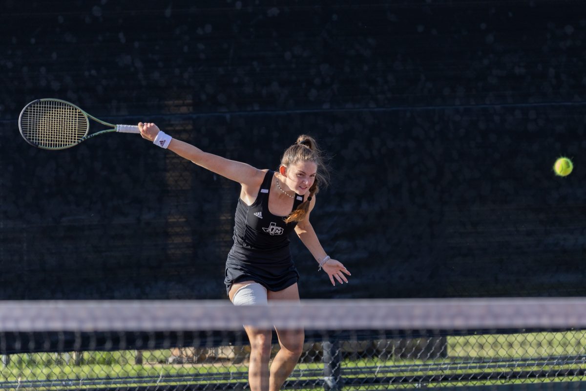 Sophomore Nicole Khirin swings on Friday, April 12, 2024, at Mitchell Tennis Center. (Adriano Espinosa/The Battalion)