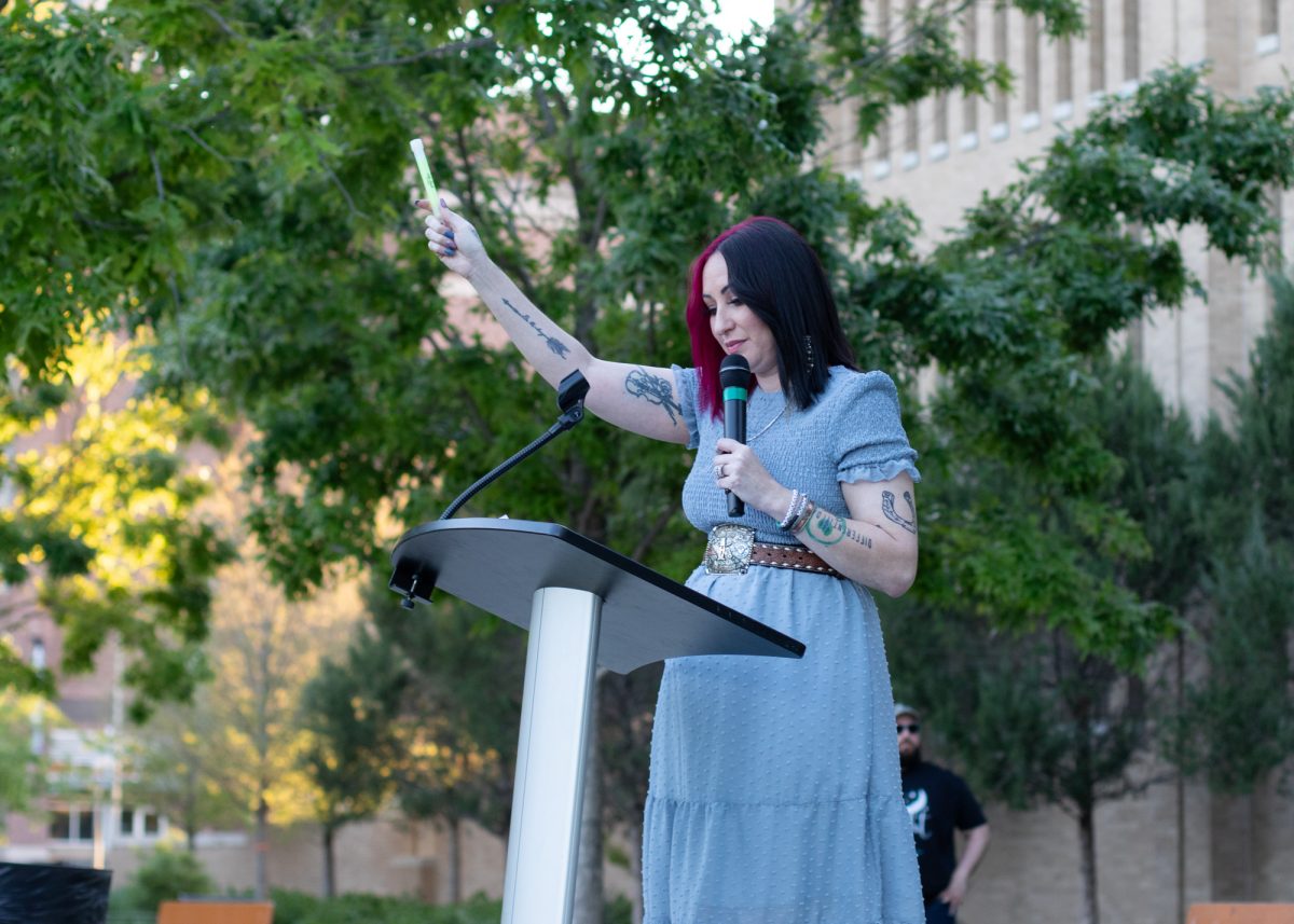 Keynote speaker Marcy Bartula, founder of the Different Day Foundation, leads the candlelight moment of empowerment at the Take Back the Night event in Aggie Park on Wednesday, March 3, 2024. (Kyle Heise/The Battalion)