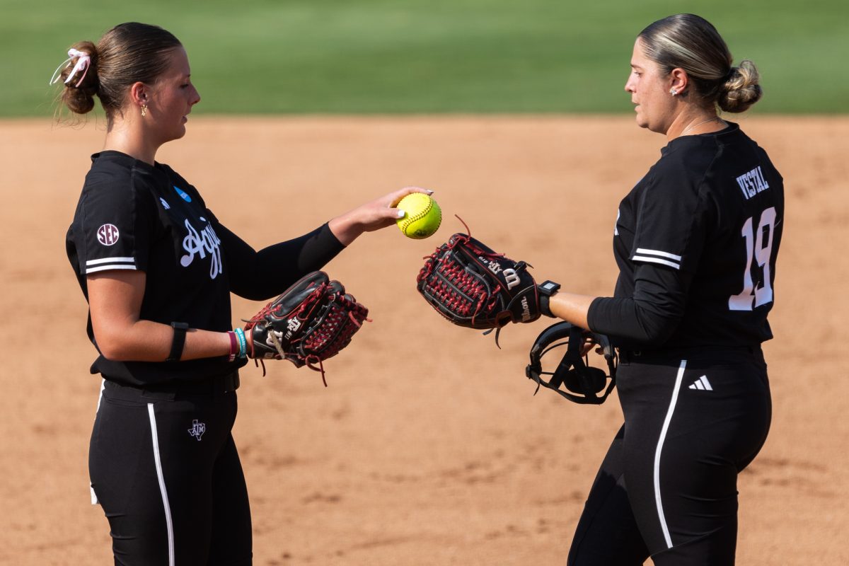 Texas A&amp;M starting pitcher/relief pitcher Emiley Kennedy (11) hands the ball to starting pitcher/relief pitcher Brooke Vestal (19) during Texas A&amp;M’s game against Texas at the Austin Super Regional at Red and Charline McCombs Field in Austin, Texas, on Saturday, May 25, 2024. (CJ Smith/The Battalion)