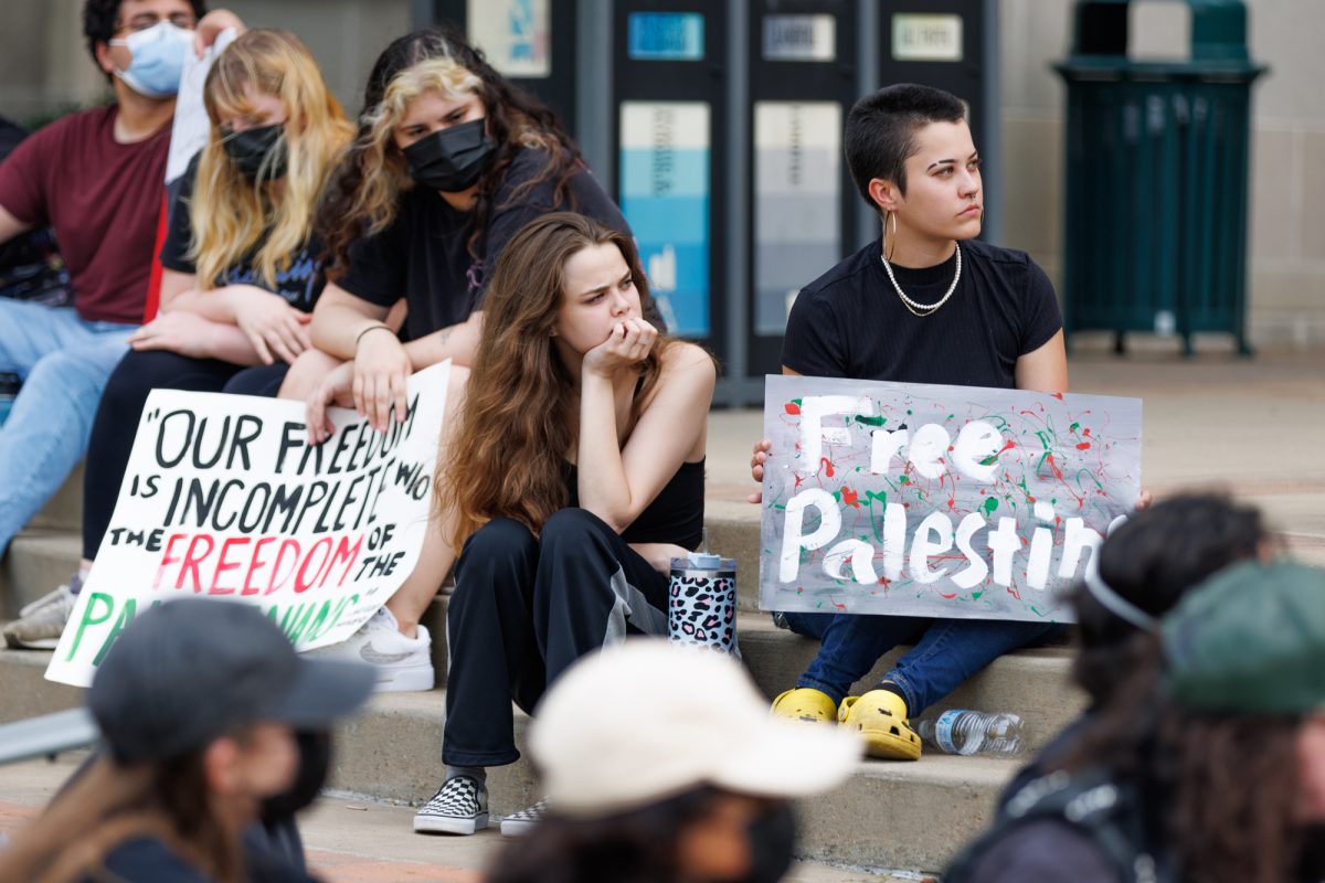 Demostrators sit at the architecture quad while listening to names of people who died during the Isreal-Hamas conflict at the free Palestine protest on May 7, 2024. (Samuel Falade/The Battalion)