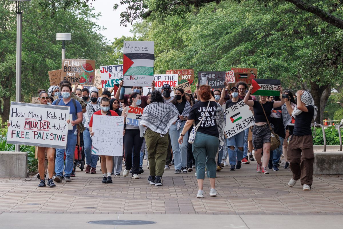Demostrators walk back towards Rudder tower during the free Palestine protest on May 7, 2024. (Samuel Falade/The Battalion)