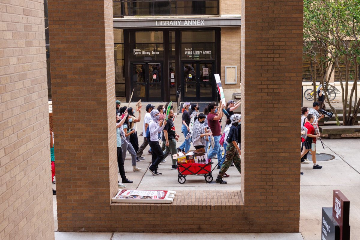 Demostrators walk beside Evans library during the free Palestine protest on May 7, 2024. (Samuel Falade/The Battalion)