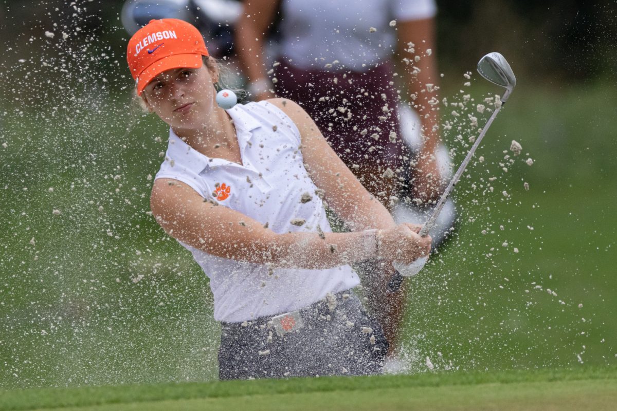 Clemson Sophomore Isabella Rawl hits the ball out of a sand pit during the Bryan Regional of the NCAA Women’s Golf Championship at Traditions Golf Club on Monday, May 6, 2024. (Chris Swann/ The Battalion)