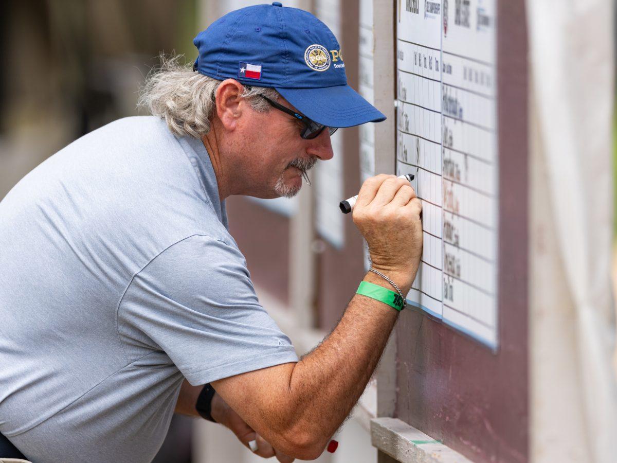 A scorekeeper updates the score cards during the Bryan Regional of the NCAA Women’s Golf Championship at Traditions Golf Club on Monday, May 6, 2024. (Chris Swann/ The Battalion)
