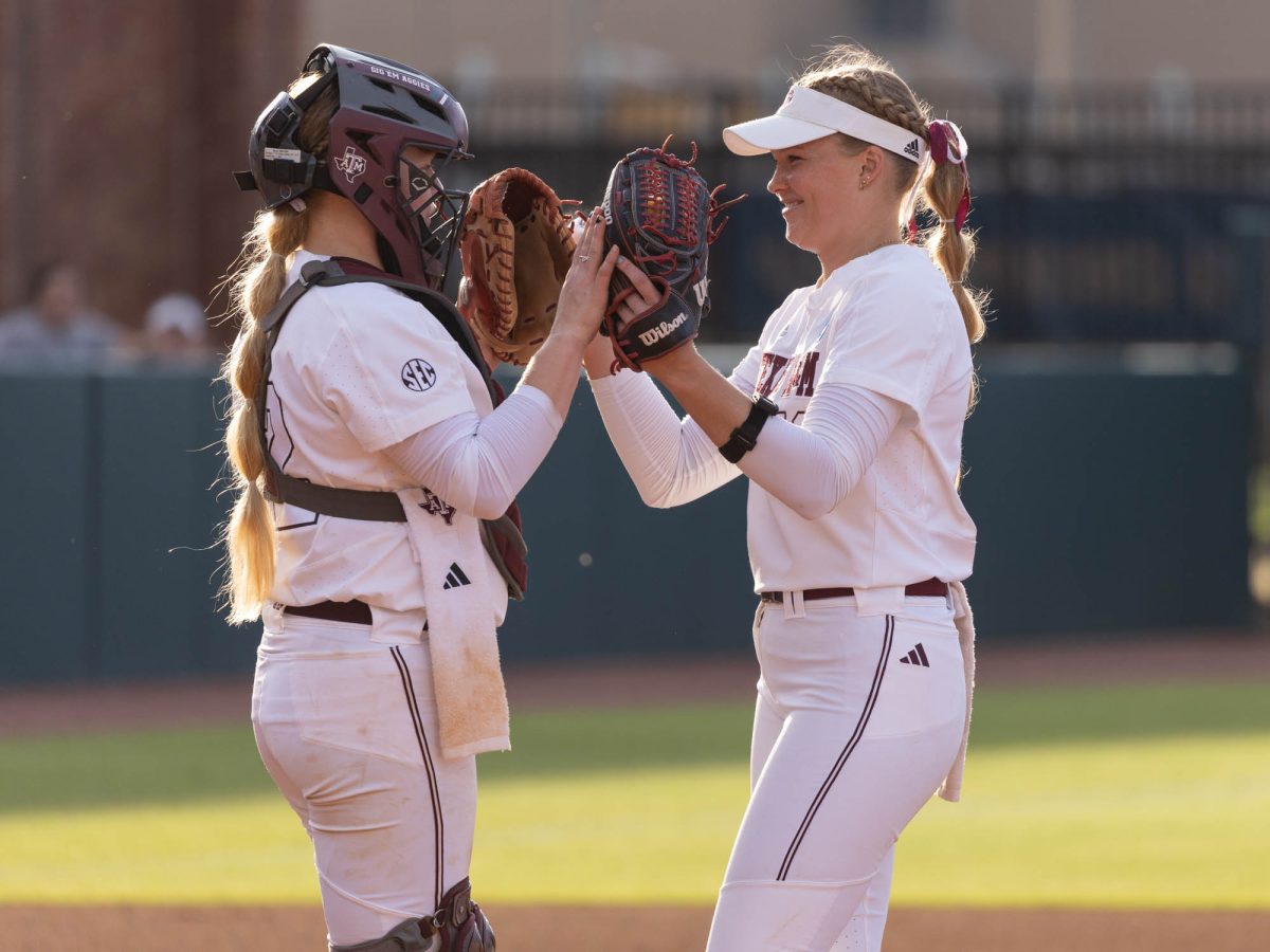 Texas A&amp;M catcher Julia Cottrill (42) high-fives Texas A&amp;M starting pitcher/relief pitcher Shaylee Ackerman (10) during Texas A&amp;M’s game against UAlbany at the first round of the NCAA Women’s College World Series at Davis Diamond on Friday, May 18, 2024. (Hannah Harrison/The Battalion)