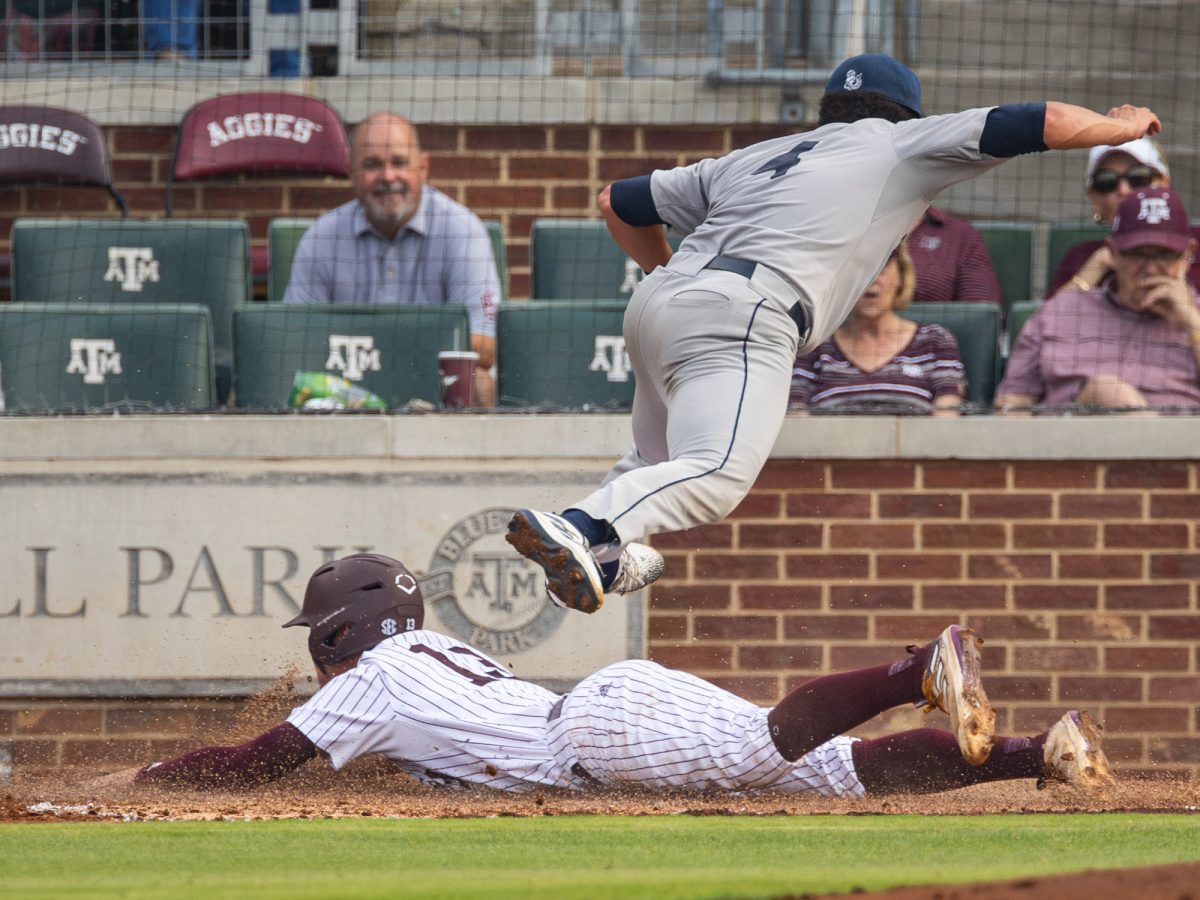 Texas A&M outfielder Caden Sorrell (13) dives into first during Texas A&M’s game against Rice at Olsen Field on Tuesday, May 7, 2024. (Chris Swann/The Battalion)