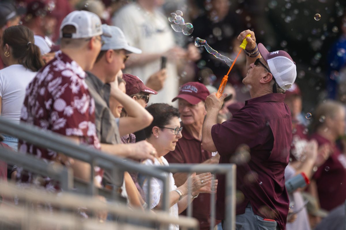 A fan blows bubbles after a home run during Texas A&M’s game against Rice at Olsen Field on Tuesday, May 7, 2024. (Chris Swann/The Battalion)