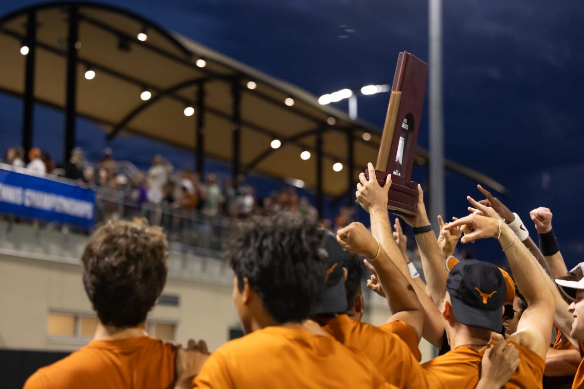 Texas men’s tennis team players raise the NCAA Super Regionals trophy after Texas A&M’s loss against Texas at Texas Tennis Center in Austin on Friday, May 10, 2024. (Chris Swann/The Battalion)