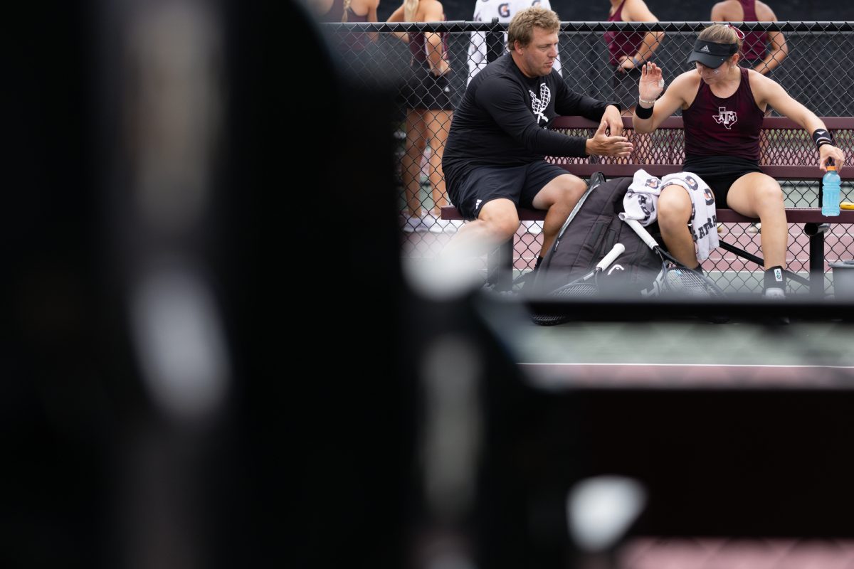 Associate Head Coach Jordan Szabo talks to Junior Mary Sttoiana in between sets during Texas A&M’s match against Oklahoma in the second round of NCAA Women’s Tennis Regional at Mitchell Tennis Center on Sunday, May 5, 2024. (Chris Swann/The Battalion)