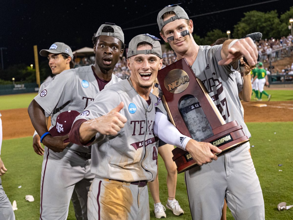 Texas A&M pitcher Eldridge Armstrong III (15), utility Travis Chestnut (4), and infielder Ted Burton (27) pose for a picture after The Aggies win the NCAA Bryan-College Station Super Regional at Olsen Field on Sunday, June 9, 2024. (CJ Smith/The Battalion)