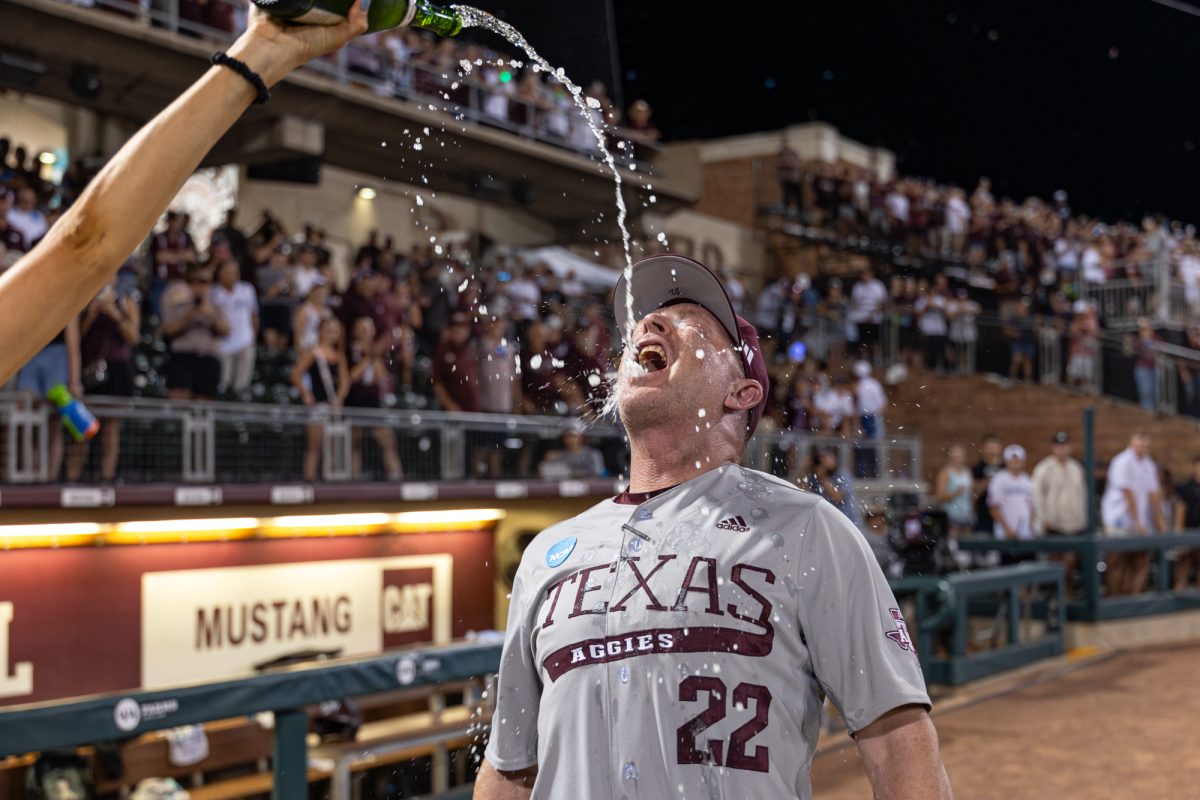 Texas A&M head coach Jim Schlossnagle celebrates after The Aggies win the NCAA Bryan-College Station Super Regional at Olsen Field on Sunday, June 9, 2024. (CJ Smith/The Battalion)