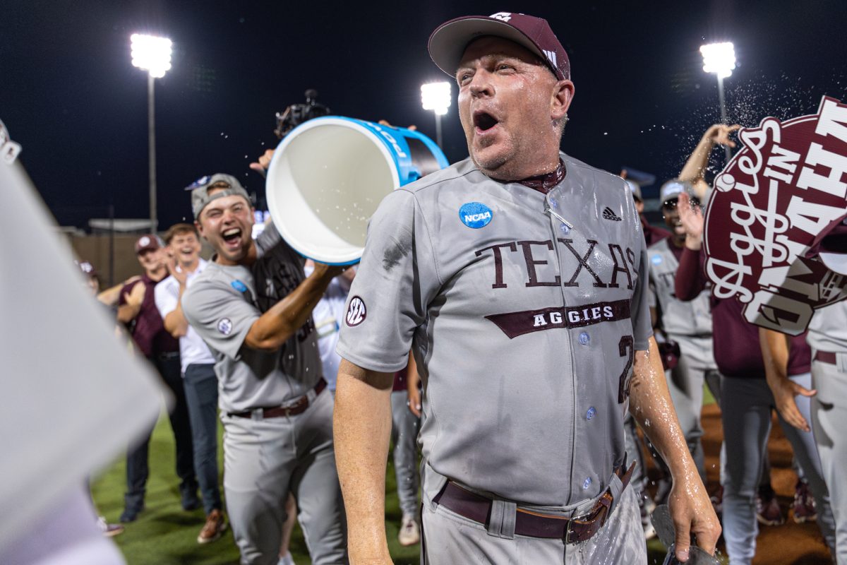 Texas A&M head coach Jim Schlossnagle reacts to getting water poured on him after the NCAA Bryan-College Station Super Regional at Olsen Field on Sunday, June 9, 2024. (CJ Smith/The Battalion)