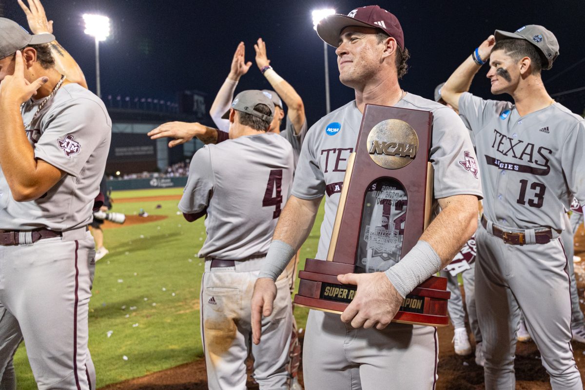 Texas A&M infielder Ryan Targac (12) holds the NCAA Super Regional trophy after The Aggies win the NCAA Bryan-College Station Super Regional at Olsen Field on Sunday, June 9, 2024. (CJ Smith/The Battalion)