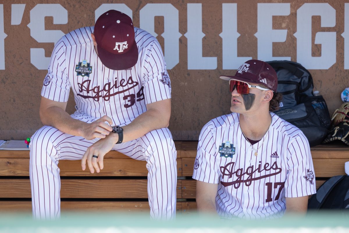 Texas A&M outfielder Jace LaViolette (17) sits beside associate head coach Nolan Cain (39) before Texas A&M’s game against Tennessee at the NCAA Men’s College World Series finals at Charles Schwab Field in Omaha, Nebraska on Saturday, June 22, 2024. (Chris Swann/The Battalion)