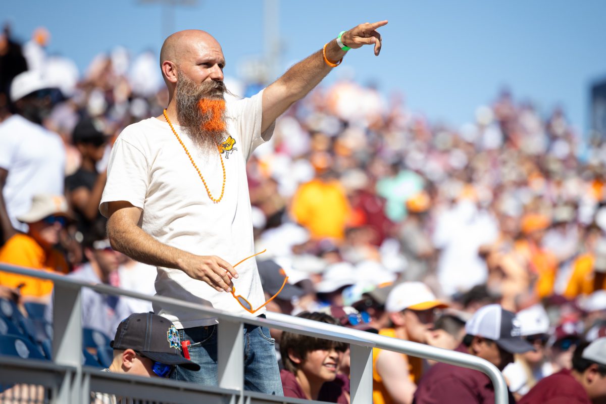 A Tennessee fan points towards the field during Texas A&M’s game against Tennessee at the NCAA Men’s College World Series finals at Charles Schwab Field in Omaha, Nebraska on Saturday, June 22, 2024. (Chris Swann/The Battalion)