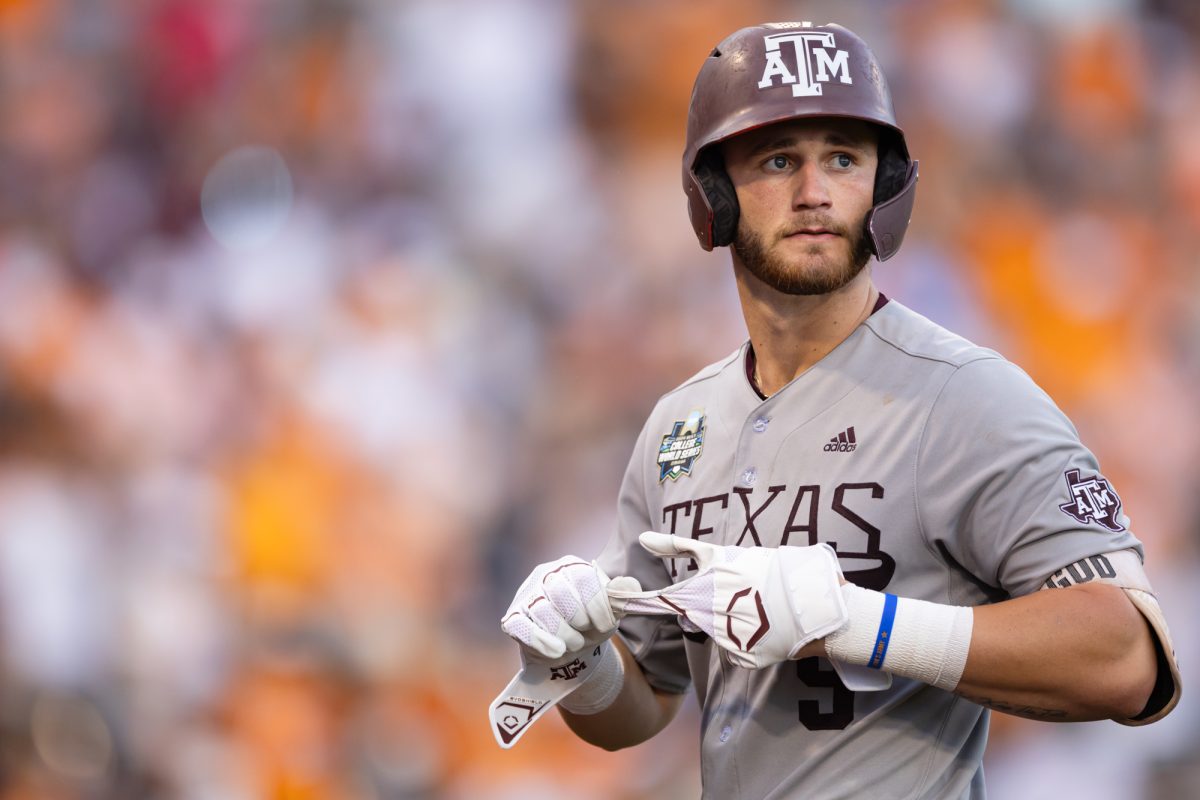 Texas A&M utility Gavin Grahovac (9) walks abck to the dugout after striking out during Texas A&M’s game against Tennessee at the NCAA Men’s College World Series finals at Charles Schwab Field in Omaha, Nebraska on Monday, June 24, 2024. (Chris Swann/The Battalion)