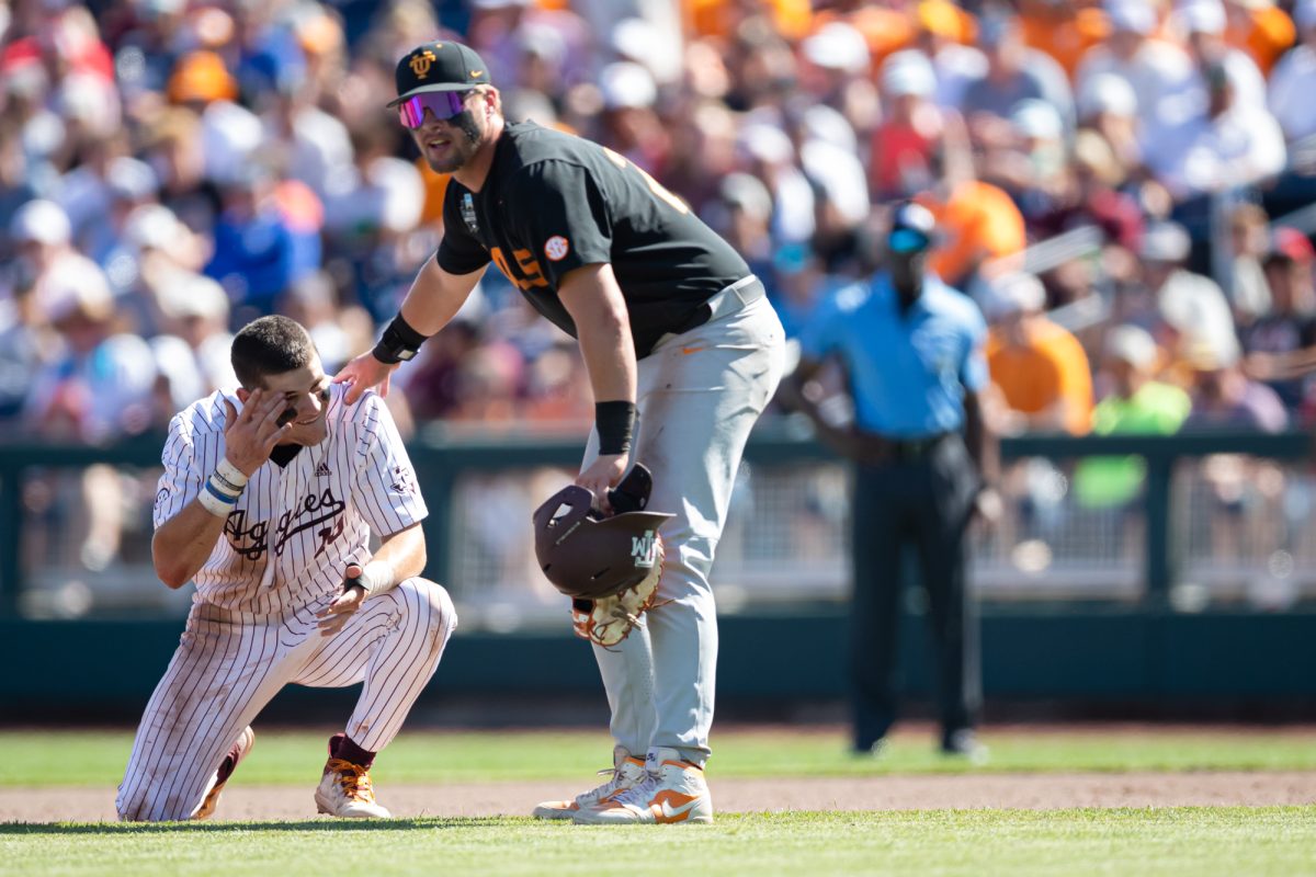 Tennessee first baseman Blake Burke (25) checks on Texas A&M outfielder Caden Sorrell (13) after a collision beween Sorrel and Tennessee infielder Ariel Antigua (2) during Texas A&M’s game against Tennessee at the NCAA Men’s College World Series finals at Charles Schwab Field in Omaha, Nebraska on Saturday, June 22, 2024. (Chris Swann/The Battalion)