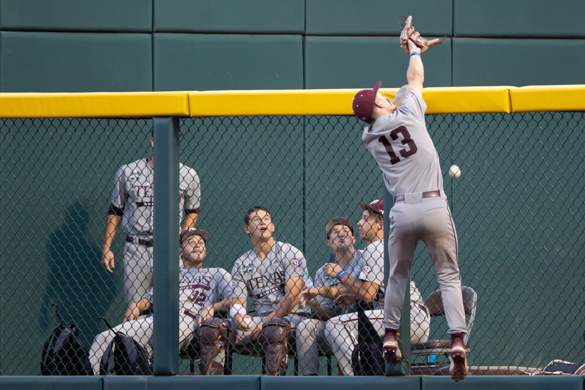Texas A&M outfielder Caden Sorrell (13) attempts to catch a Tennessee home-run during Texas A&M’s game against Tennessee at the NCAA Men’s College World Series finals at Charles Schwab Field in Omaha, Nebraska on Monday, June 24, 2024. (Chris Swann/The Battalion)