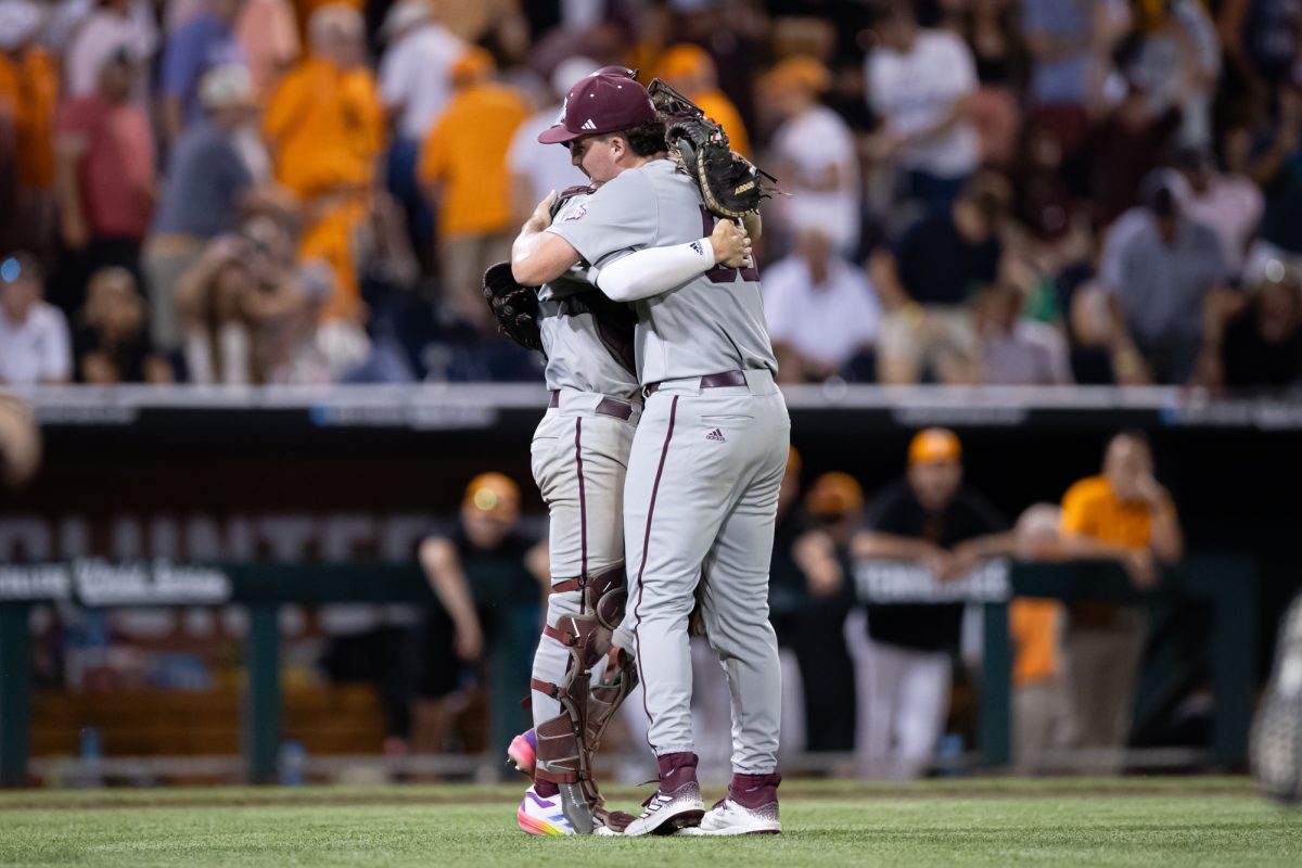 Texas A&M pitcher Evan Aschenbeck (53) hugs Texas A&M catcher Jackson Appel (20) after Texas A&M’s win against Tennessee at the NCAA Men’s College World Series finals at Charles Schwab Field in Omaha, Nebraska on Saturday, June 22, 2024. (Chris Swann/The Battalion)