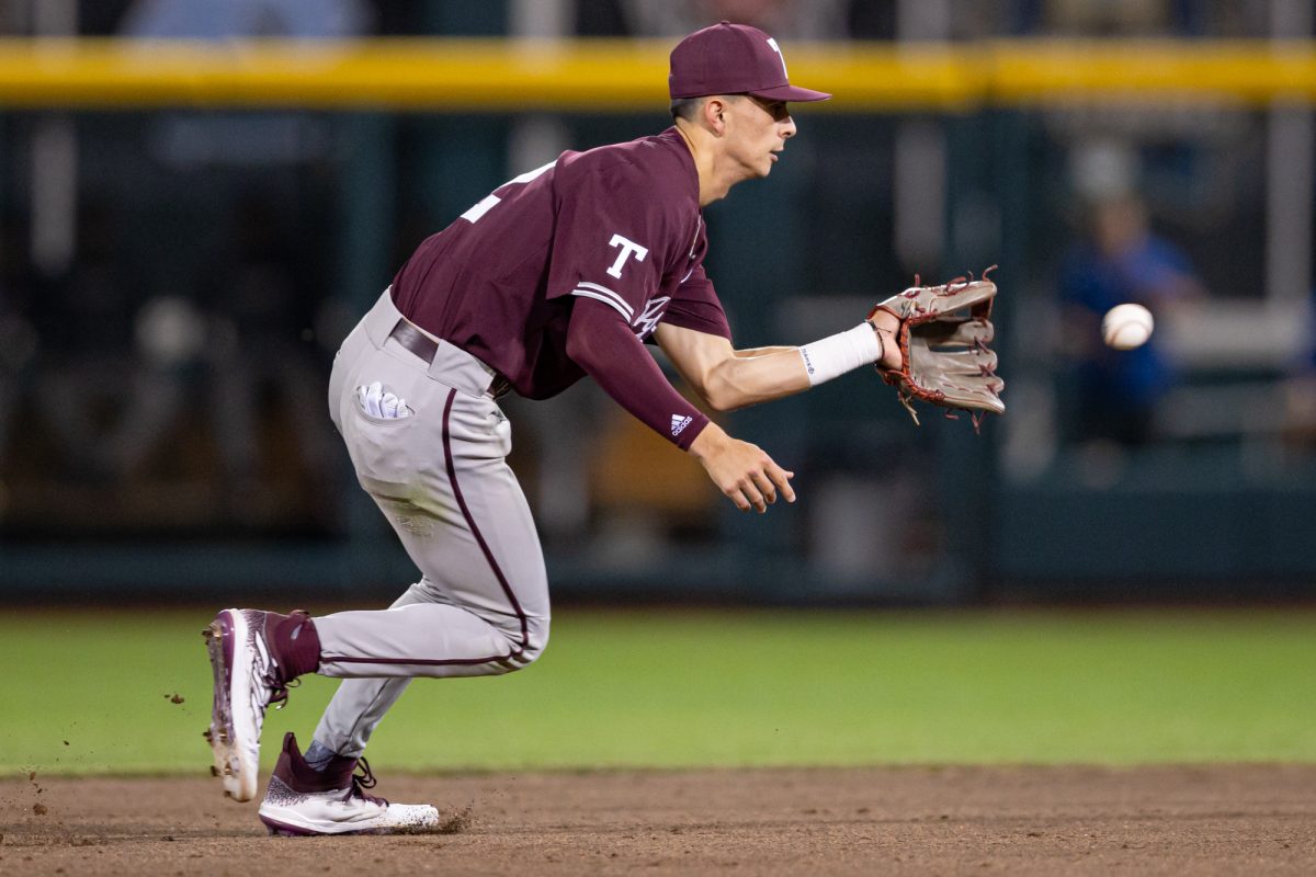 Texas A&M infielder Kaeden Kent (3) fields the ball before making the game-ending double play during Texas A&M’s game against Florida at the NCAA Men’s College World Series semifinals at Charles Schwab Field in Omaha, Nebraska on Wednesday, June 19, 2024. (Chris Swann/The Battalion)