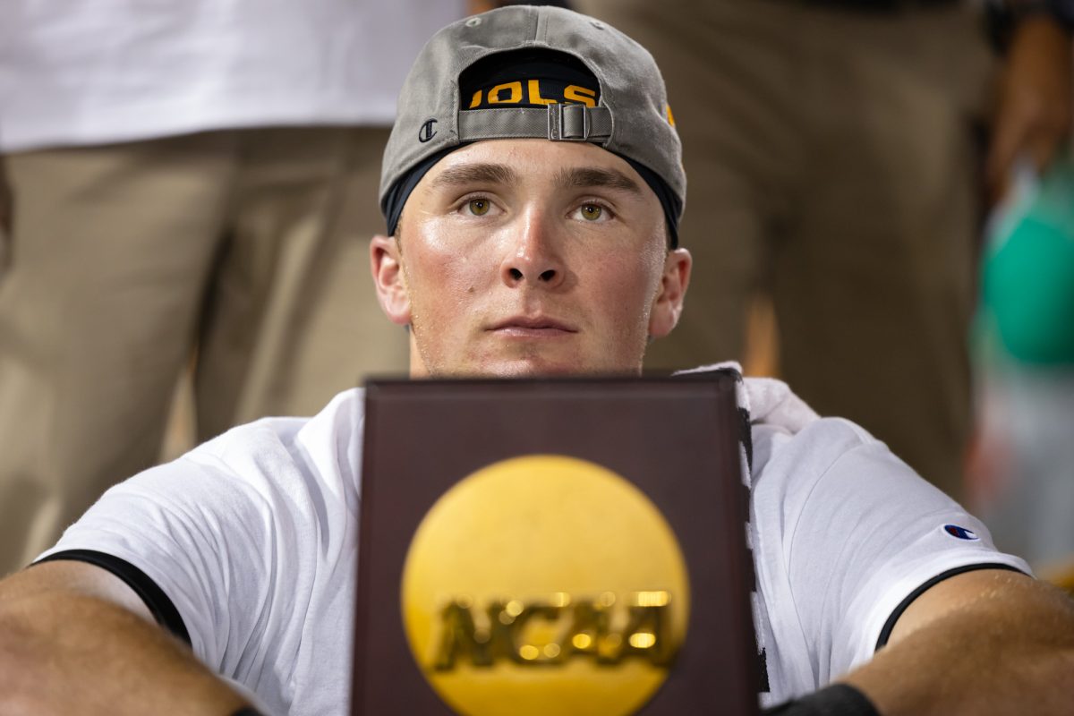 Tennessee outfielder Dylan Dreiling (8) watches a video on the scoreboard with the National Championship trophy after Tennessee’s win against Texas A&M at the NCAA Men’s College World Series finals at Charles Schwab Field in Omaha, Nebraska on Monday, June 24, 2024. (Chris Swann/The Battalion)