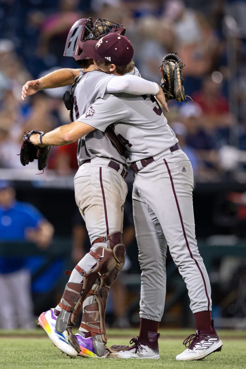 Texas A&M pitcher Josh Stewart (34) hugs Texas A&M catcher Jackson Appel (20) after the final strikeout to secure Texas A&M’s win against Kentucky at the NCAA Men’s College World Series at in Omaha, Nebraska on Monday, June 17, 2024. (Chris Swann/The Battalion)