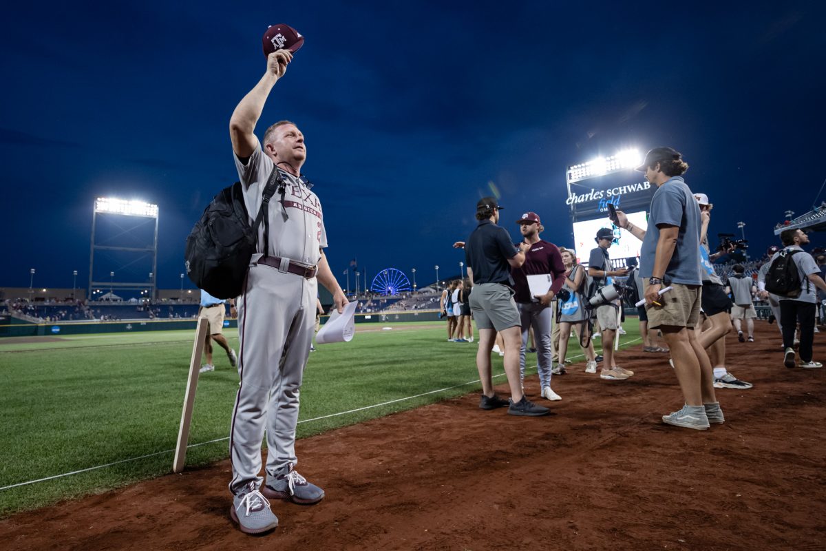 Texas A&M head coach Jim Schlossnagle (22) waves to the crowd after Texas A&M’s win against Kentucky at the NCAA Men’s College World Series at in Omaha, Nebraska on Monday, June 17, 2024. (Chris Swann/The Battalion)