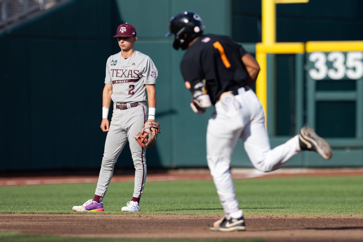 Texas A&M infielder Ali Camarillo (2) watches as Tennessee infielder Christian Moore (1) rounds second after hitting a home run during Texas A&M’s game against Tennessee at the NCAA Men’s College World Series finals at Charles Schwab Field in Omaha, Nebraska on Monday, June 24, 2024. (Chris Swann/The Battalion)