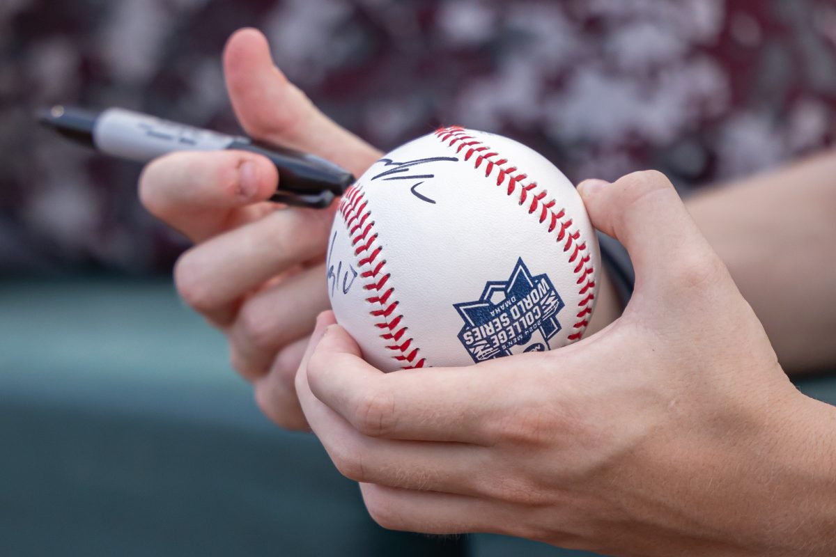 A fan holds a signed College World Series Baseball before Texas A&M’s game against Kentucky at the NCAA Men’s College World Series at in Omaha, Nebraska on Monday, June 17, 2024. (Chris Swann/The Battalion)