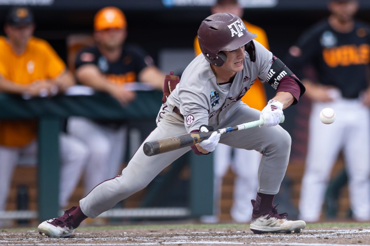 Texas A&M infielder Travis Chestnut (4) bunts the ball during Texas A&M’s game against Tennessee at the NCAA Men’s College World Series finals at Charles Schwab Field in Omaha, Nebraska on Monday, June 24, 2024. (Chris Swann/The Battalion)