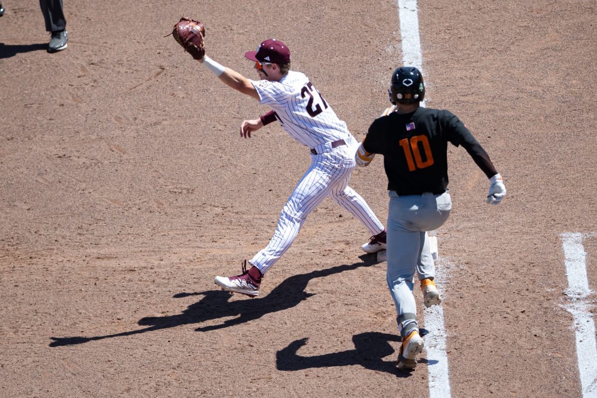 Texas A&M infielder Ted Burton (27) catvhes the ball to force Tennessee catcher Cal Stark (10) out during Texas A&M’s game against Tennessee at the NCAA Men’s College World Series finals at Charles Schwab Field in Omaha, Nebraska on Saturday, June 22, 2024. (Chris Swann/The Battalion)