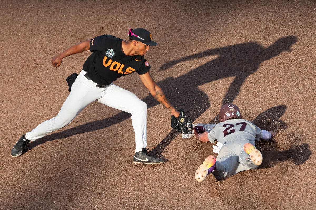 Tennessee infielder Christian Moore (1) attempts to tag out Texas A&M infielder Ted Burton (27) during Texas A&M’s game against Tennessee at the NCAA Men’s College World Series finals at Charles Schwab Field in Omaha, Nebraska on Monday, June 24, 2024. (Chris Swann/The Battalion)