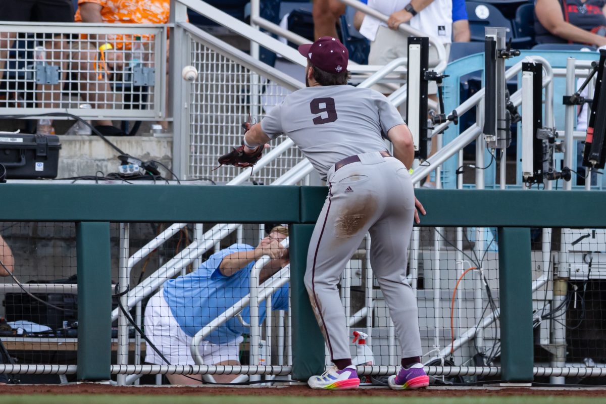 Texas A&M utility Gavin Grahovac (9) attempts to catch the foul ball during Texas A&M’s game against Tennessee at the NCAA Men’s College World Series finals at Charles Schwab Field in Omaha, Nebraska on Monday, June 24, 2024. (Chris Swann/The Battalion)