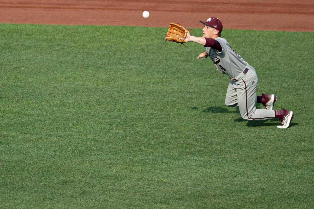 Texas A&M infielder Travis Chestnut (4) catches a pop fly during Texas A&M’s game against Kentucky at the NCAA Men’s College World Series at in Omaha, Nebraska on Monday, June 17, 2024. (Chris Swann/The Battalion)