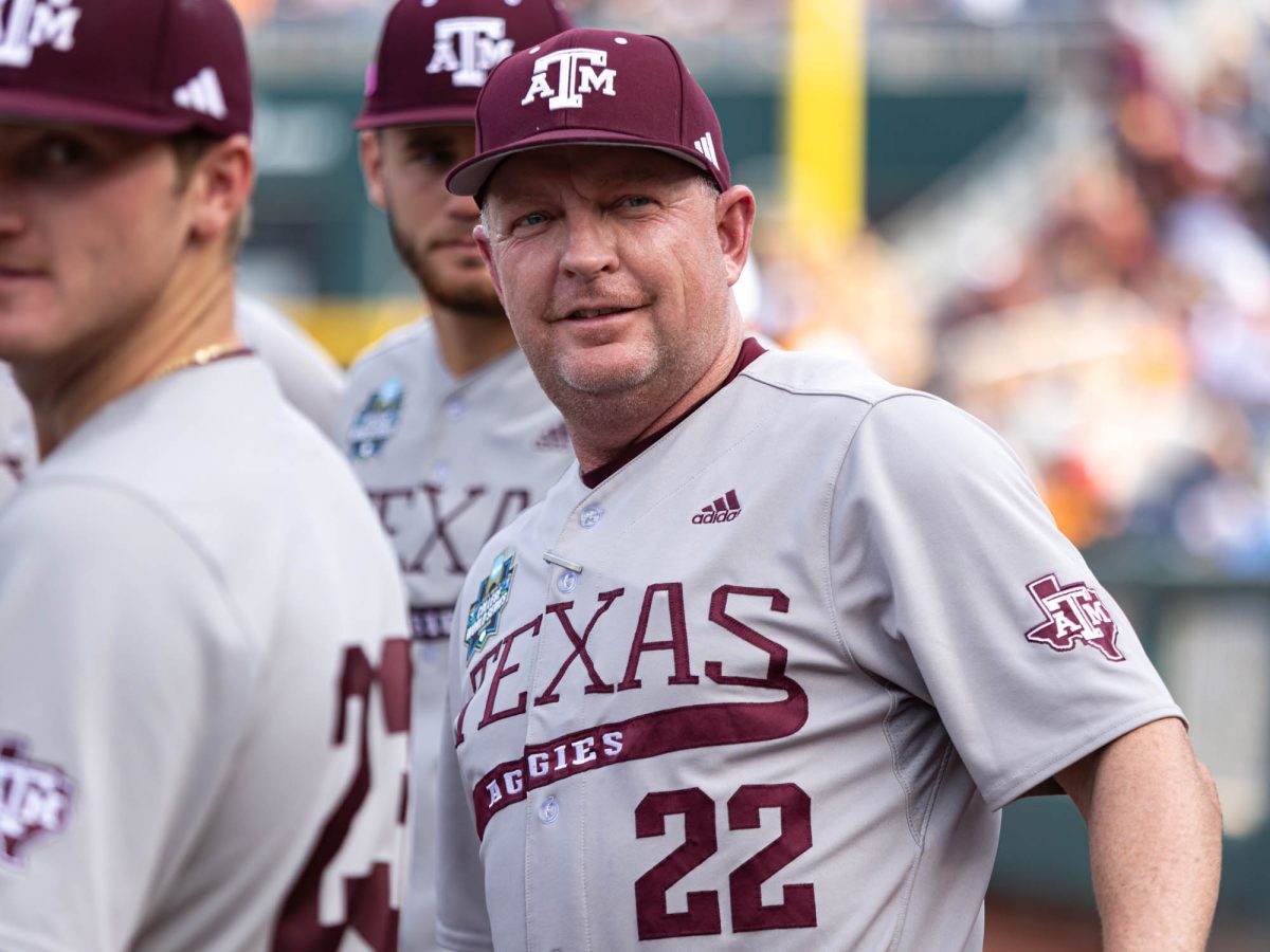 Texas A&M Head Coach Jim Schlossnagle stands in a huddle during Texas A&M’s game against Tennessee at the NCAA Men’s College World Series finals at Charles Schwab Field in Omaha, Nebraska on Saturday, June 22, 2024. (Hannah Harrison/The Battalion)