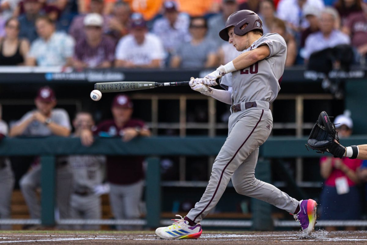 Texas A&M catcher Jackson Appel (20) makes contact with a ball for a double during Texas A&M’s game against Tennessee at the NCAA Men’s College World Series finals at Charles Schwab Field in Omaha, Nebraska on Saturday, June 22, 2024. (Hannah Harrison/The Battalion)
