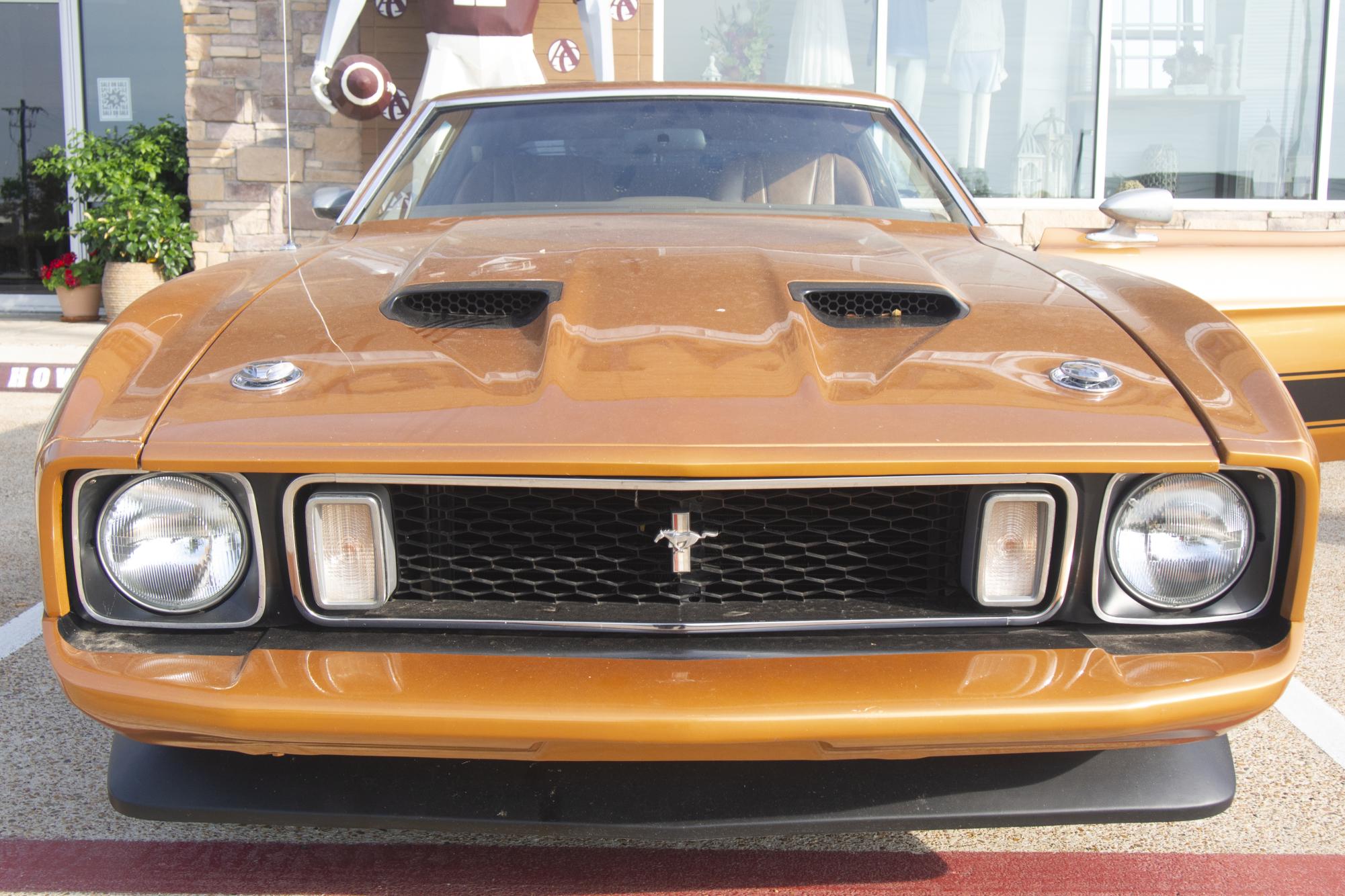 Craig Reagan's 1973 brown Mach 1 Mustang features custom stickers of Craig and his wife, and is completely rebuilt from the ground up. The interior was completely torn out and replaced with new dashboard and radio.