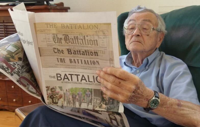 Bob Rogers, holding a special edition of The Battalion.